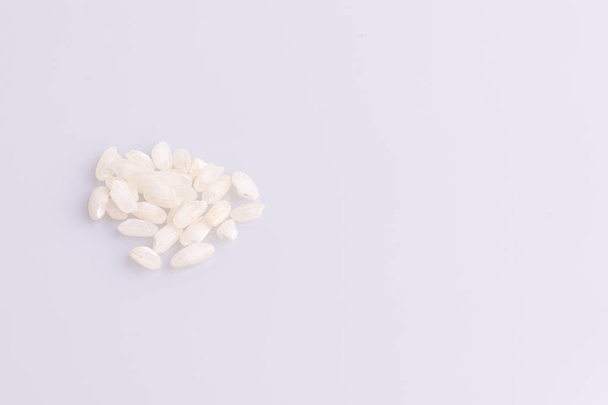 Heap of Italian Risotto riceon white background. Top View. Copy Space. Soft light. Latin term "Oryza sativa". Carnaroli rice. Vialone Nano rice. - 写真・画像