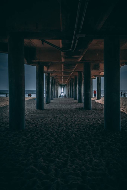 Underneath area of the wooden long pier at the coast of a beautiful sea - Фото, зображення
