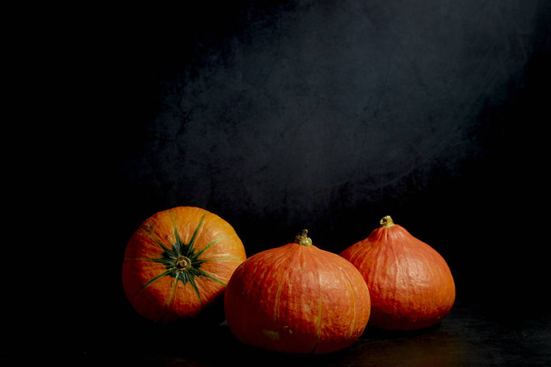 Three Pumpkins in black background - Фото, изображение