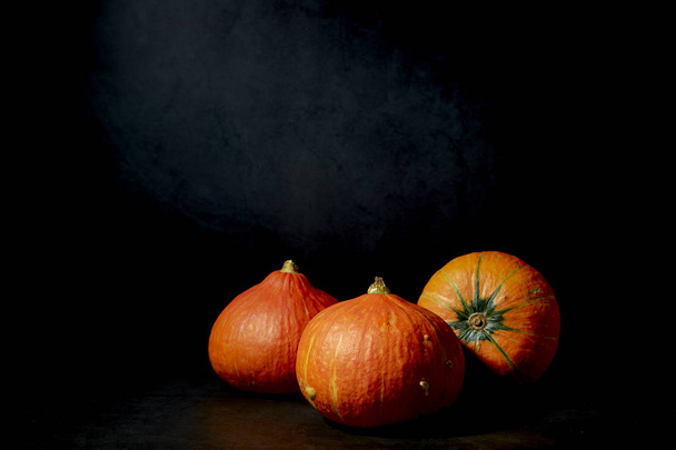 Three Pumpkins in black background - Foto, afbeelding