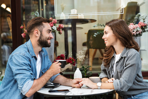 Attractive young couple in love having lunch - 写真・画像