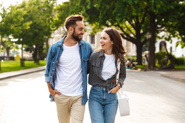 Beautiful young couple in love walking outdoors at the city street - Foto, imagen
