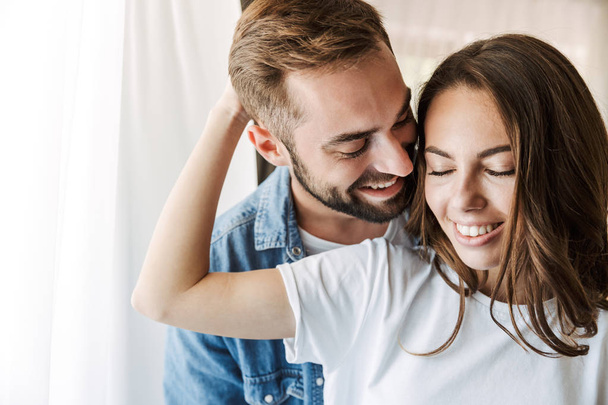 Beautiful young couple in love at home - Fotografie, Obrázek