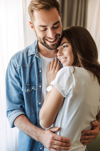 Beautiful young couple in love at home - Foto, Bild