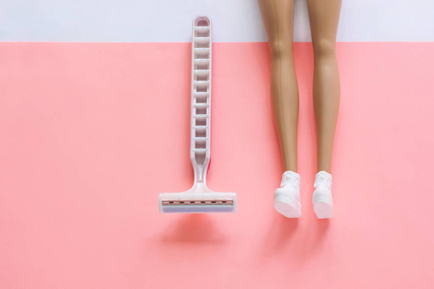 Disposable shaving machine for women on a pink pastel background, flatley, copy space. - Fotó, kép