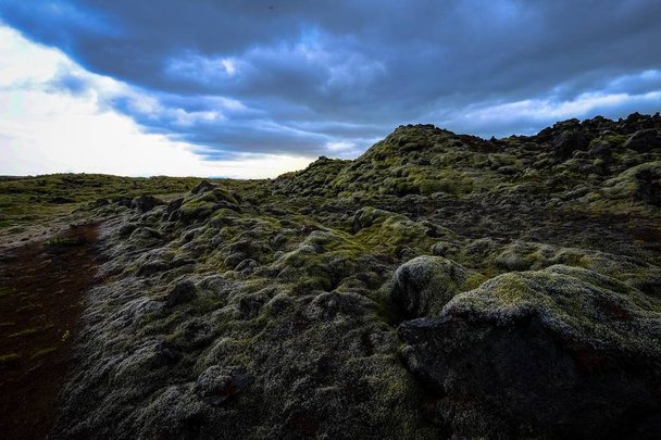 Beautiful shot of  mossy rocks and hills under a cloudy sky - Foto, Imagem