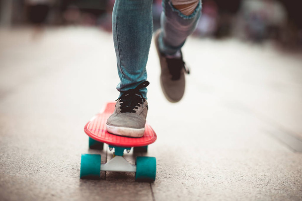 Skateboarder legs skateboarding at city - Fotografie, Obrázek