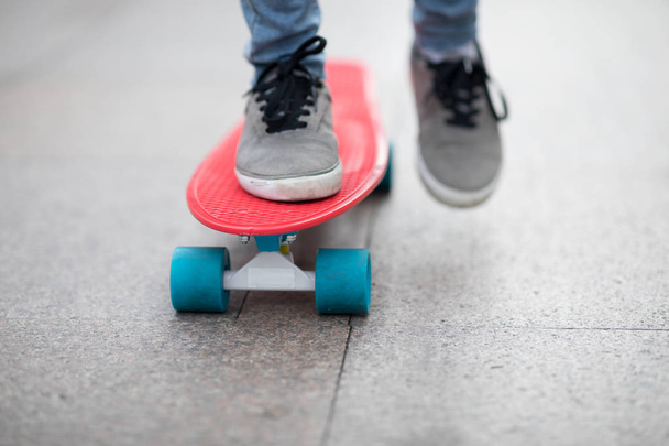 Skateboarder legs skateboarding at city - Фото, изображение