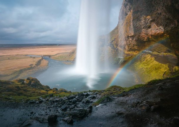 Beautiful shot of a field with waterfalls on hills - Foto, Imagen