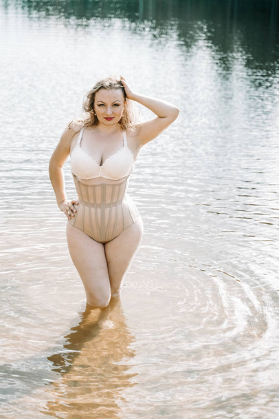plus size woman with curvy figure in corset lingerie. caucasian xxl chubby girl wanna swimming. - Photo, image