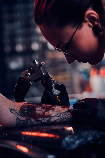 Process of tattoo makining at dark tattoo studio. - Photo, Image
