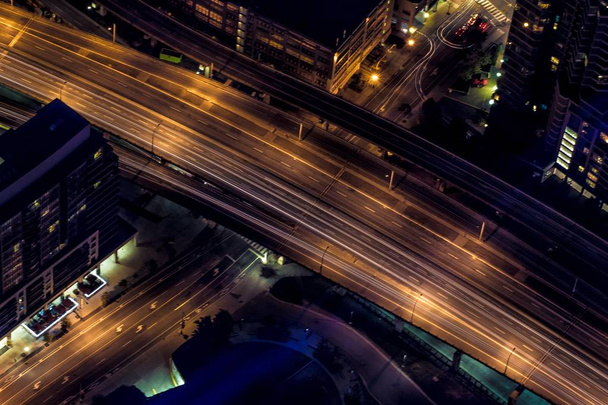 An aerial shot of urban city highway at night - Фото, зображення