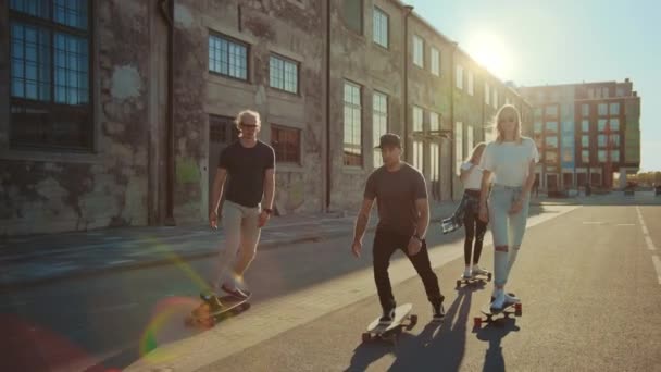Group of Girls and Boys on Skateboards Ride Through Fashionable Hipster District. Beautiful Young People Skateboarding Through Modern Stylish City Street. Moving Slow Motion Portrait Camera Shot - Video