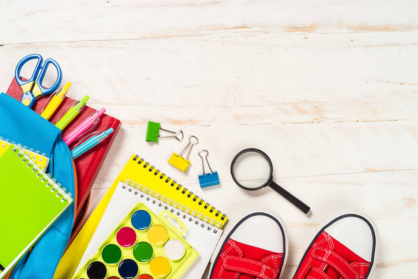 School backpack with stationery on white background. - Photo, Image
