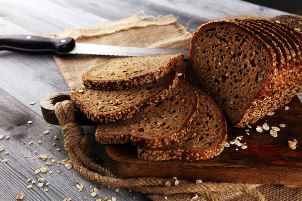 świeżo upieczony chleb na drewnianej płycie. wycinany chleb organiczny - Zdjęcie, obraz