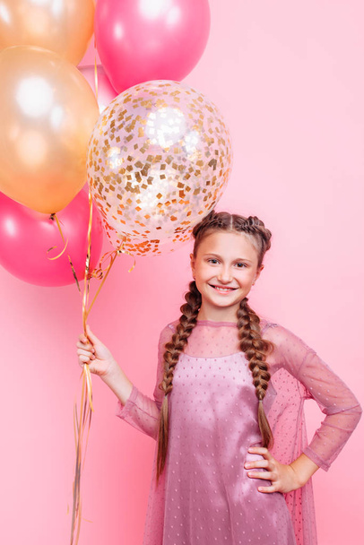 Happy and beautiful teen girl holding a bunch of colorful balloo - Valokuva, kuva
