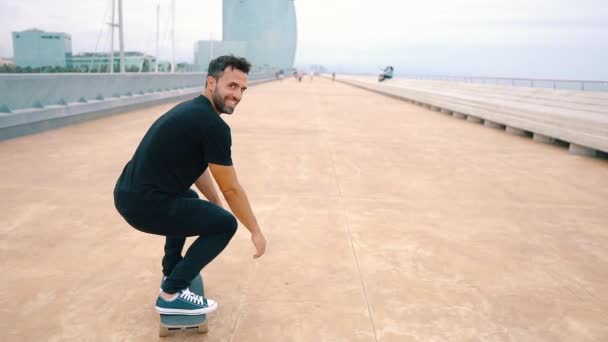 Skateboarder rides a skateboard in the modern city terrace. - Felvétel, videó