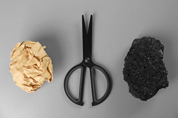 Flat lay composition with rock, paper and scissors on grey background - 写真・画像