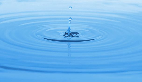 Splash of blue water with drop, closeup - Valokuva, kuva