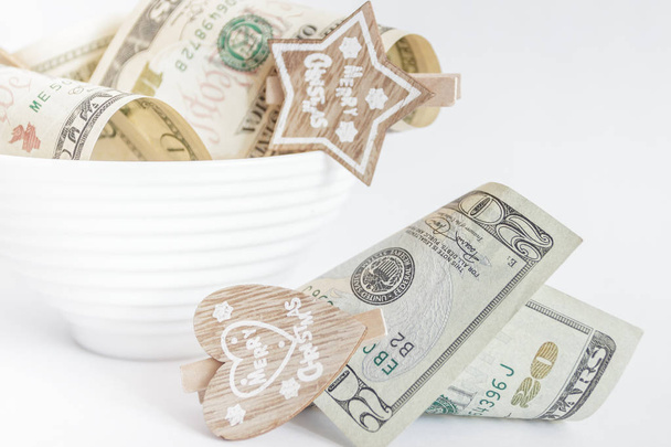 American dollars with decorative clothes pins in the ceramic bowl - Fotoğraf, Görsel