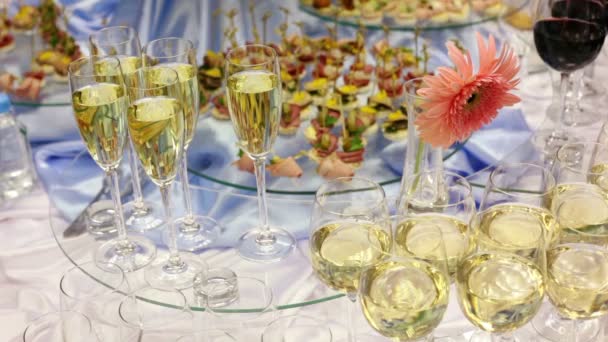 Hand take glass of champagne from appetizer table with canape and other delights - Felvétel, videó