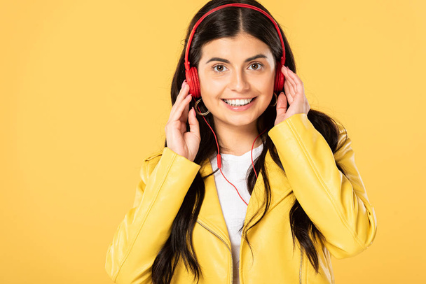 ヘッドフォンで音楽を聴く笑顔の女の子, 黄色で隔離  - 写真・画像