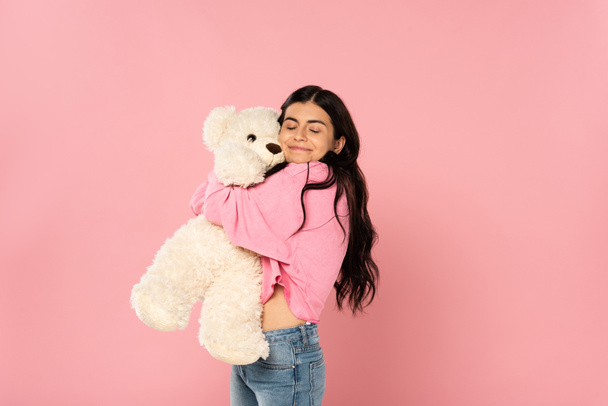 beautiful happy girl hugging teddy bear, Isolated On pink - Foto, immagini
