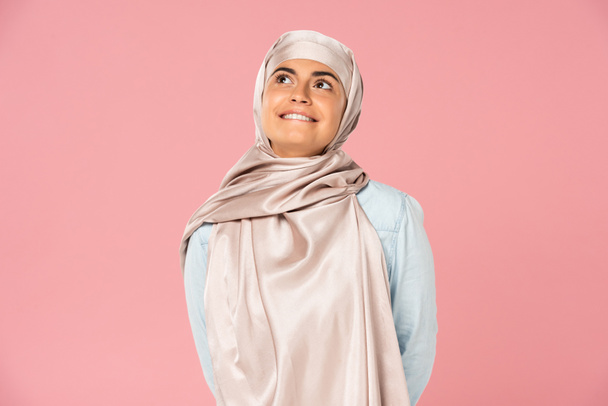beautiful dreamy muslim girl in hijab, isolated on pink - Photo, Image