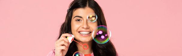 cheerful young woman blowing soap bubbles isolated on pink - Fotoğraf, Görsel