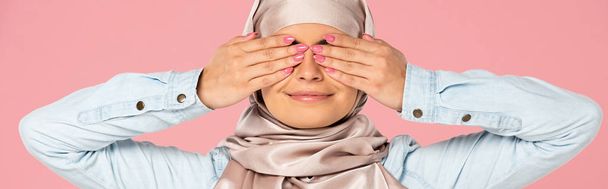 smiling muslim girl in hijab closing eyes, isolated on pink - Photo, Image