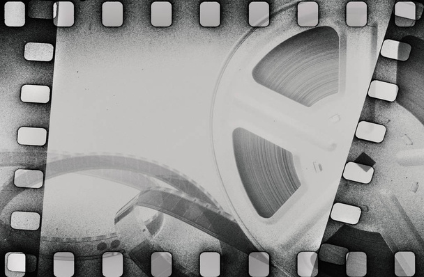Grunge scratched dirty film strip background with reel. - Photo, Image