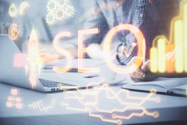 Double exposure of seo icon with man working on computer on background. Concept of search engine optimization. - Foto, Imagen
