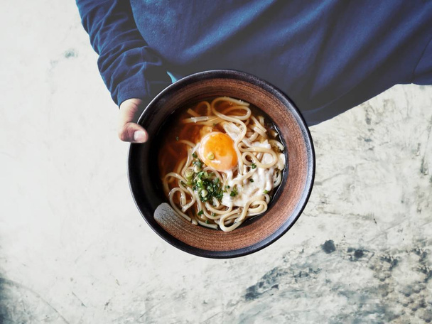 Selfie of ramen noodle soup with hand - Photo, Image