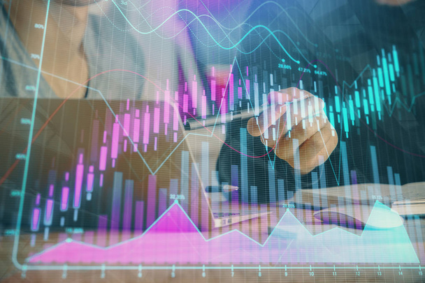 Forex graph with businessman typing on computer in office on background. Concept of analysis. Double exposure. - Foto, immagini