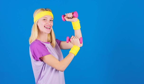 Ultimate upper body workout for women. Fitness instructor hold little dumbbell blue background. Fitness concept. Girl exercising with dumbbell. Workout with dumbbell. Beginner dumbbell exercises - Photo, image