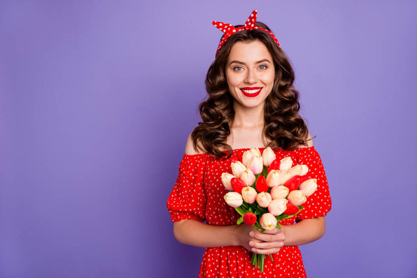 Photo of pretty lady holding big tulips bunch hands wear red dress isolated purple background - Foto, Bild