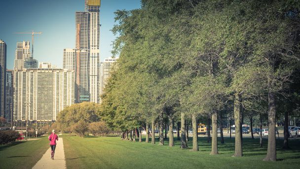 Αστικό πάρκο στο κέντρο του Σικάγο με την κυρία γυμναστικής τρέξιμο - Φωτογραφία, εικόνα