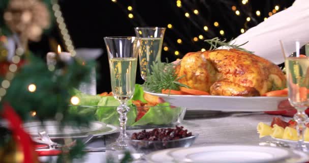 Woman hands putting roasted chicken on festive dinner Christmas table closeup. Celebrating Christmas with roasted chicken for dinner. 4k - Footage, Video