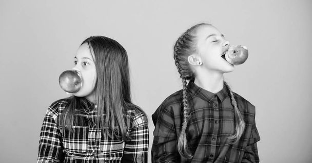 Teens with healthy snack. Cheerful kids having fun and eating apples. We are on healthy diet. Healthy dieting and vitamin nutrition. Girls friends eat apple snack while relaxing. School snack concept - Foto, Bild