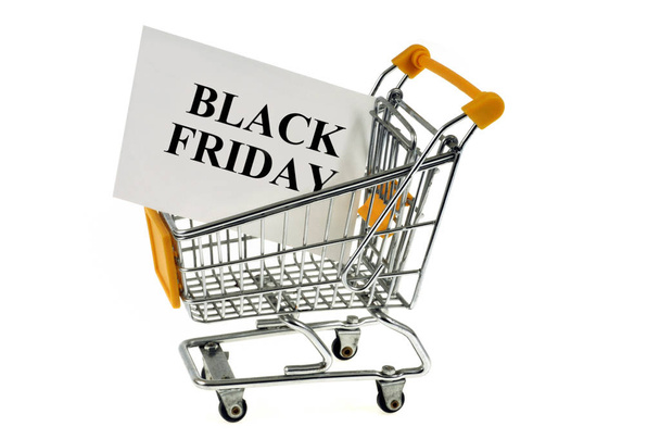 Supermarket trolley on a white background with a card on which is written black friday  - Foto, Bild