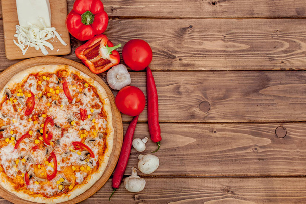 Pizza and red wine on wooden table background. Top view with cop - Φωτογραφία, εικόνα