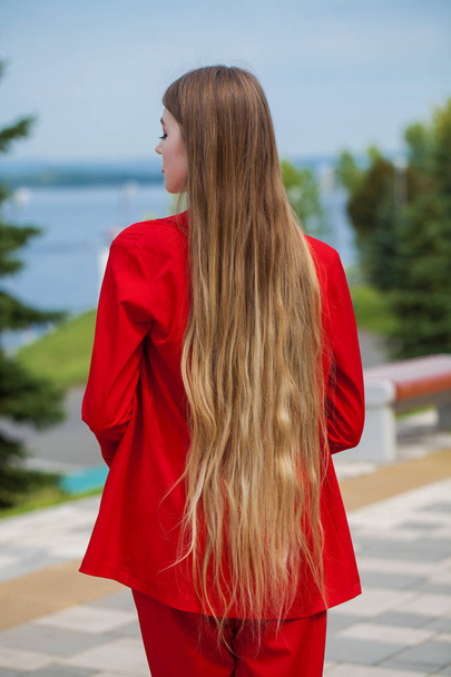 Back view close up portrait young beautiful blonde model in red  - Φωτογραφία, εικόνα