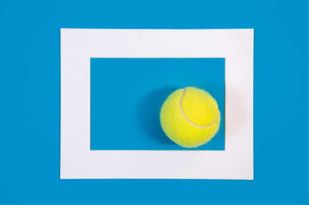 Big tennis ball on blue hard court background - Foto, imagen