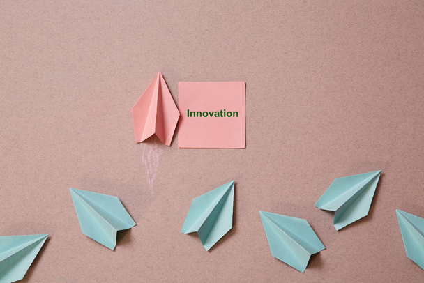 Business original idea, individuality and creativity. Success and motivation concept. Origami plane with sticker - Fotoğraf, Görsel