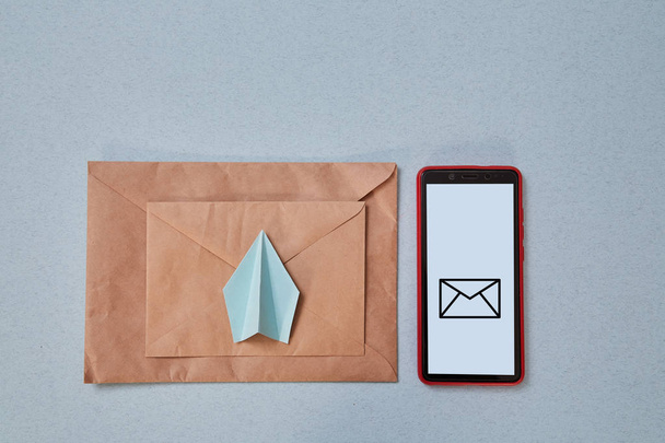 Email marketing and message online, online chat concept: Paper plane , envelope and smartphone - Zdjęcie, obraz