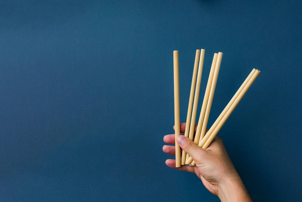 bamboo straws in a hand  - Фото, изображение