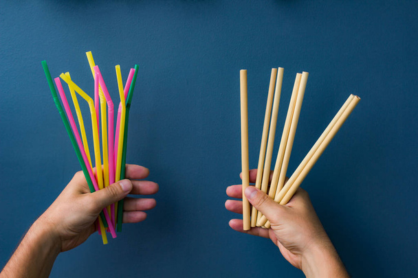 bamboo and plastic straws in hands - Φωτογραφία, εικόνα