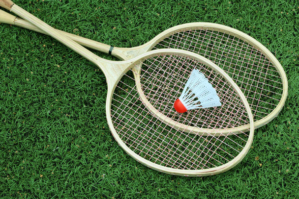 Badminton rackets on green grass - Фото, изображение