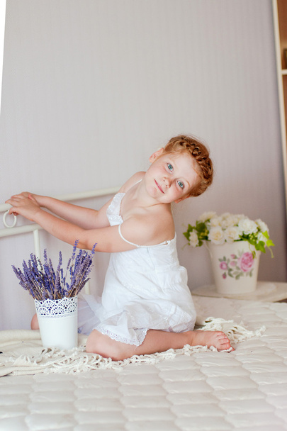 Little girl with red hair in a white dress - Photo, Image