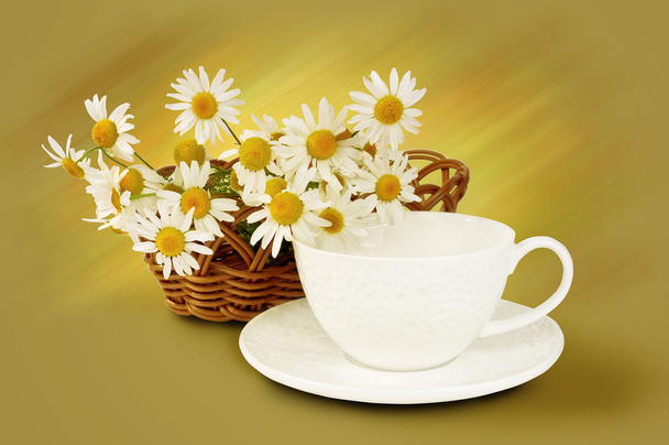 White mug and daisies in basket - Фото, изображение